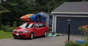 Stand at the midpoint of your car and heft the kayak over your head to sit on the j rack. How To Load A Kayak On J Rack By Yourself Safely Peaceful Paddle