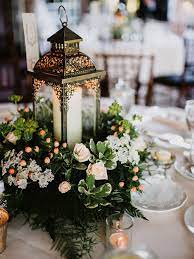 15 Beautiful Lantern Centerpieces For Any Wedding Style Lantern Centerpiece Wedding Romantic Wedding Centerpieces Wedding Floral Centerpieces