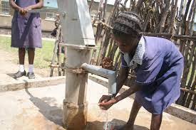 An African Girl Washes Her Hands With Clean Water Coming Out Of A Water Pump From An Operation Eyesight Borehole Wate World Water Day Eye Health Eyes Problems