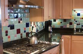 Light cabinets, dark counter, oak floors, neutral tile back splash. Recycled Glass Tile Gallery Eco Friendly Flooring
