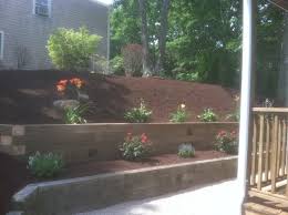 It should, at the very least, be a walkway into the tea house. Tiered Plantings Timber Wall Build Traditional Garden Boston By Harmon Sons Houzz Uk