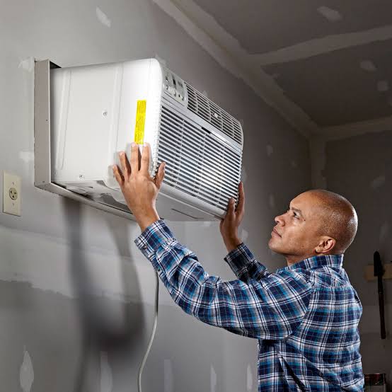 HVAC technician repairing an air conditioning unit