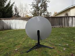 A mini satellite dish with a mounting tripod and a wifi router. Starlink Satellite Internet First Impressions The Speed And Latency Are Comfortable The Hardware Installation Is Easy 4you Dialy
