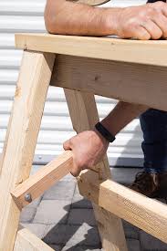 Homemade folding sawhorses constructed from 3/4 plywood, 2x4s, and hinges. Heavy Duty Diy Folding Sawhorses Video Tutorial Plans Pneumatic Addict