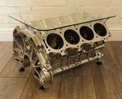The engine is a v configuration which makes it unique as the pistons hold up the glass for the table top. Reestore Evolutionary Design Our Product Range Engine Coffee Table Car Part Furniture Automotive Decor