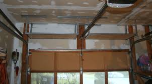 The garage, although small, is almost always treated as a storage area for basically everything that we don't want to keep in the house. Overhead Garage Shelves Using Slotted Angle Iron David Frink