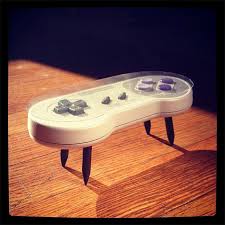I saw a few nes tables around the internet and fell in love with the idea. Snes Controller Coffee Table Get Your Feet Off My Gamepad
