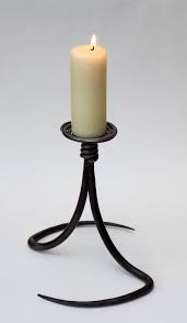 Designers have always had fun with candle holders, as these snappy little pieces demonstrate. Christhesmith Co Uk Blacksmith Candle Holder Candle Holders Wrought Iron Candle Holders