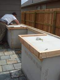 An outdoor countertop is a pleasant place to prepare dinner in hot weather, the perfect addition to a grilling area, or a great place to eat with your family. How To Build Outdoor Kitchen Cabinets Build Outdoor Kitchen Outdoor Kitchen Cabinets How To Build Outdoor Kitchen
