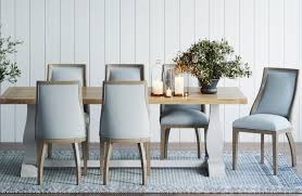 A light blue vintage lantern hangs over an oval wood dining table paired with a navy blue stripe pinstripe dining settee topped with blue striped pillows. How To Match A Dining Table With The Right Chairs Tlc Interiors