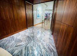 A nero polished broken joint mosaic accent wall paired with a kauri diagonal white porcelain floor creates a dark and light contrast with depth. Indoor Tile Kauri Diagonal Artistic Tile Wall Floor Porcelain Stoneware