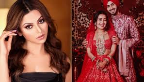 In the photo, urvashi is seen circling behind gautam in a red couple and gautam is seen walking ahead of her in people cannot believe this photo. Urvashi Rautela Makes A Statement In Lehenga And Jewellery Worth Rs 55 Lakh At Neha Kakkar S