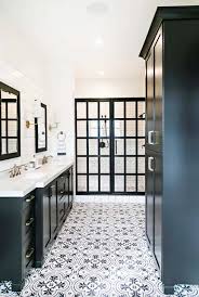Stunning master bath with white custom cabinetry, marble countertops, stand alone tub, dark flooring, and marble shower. 25 Incredibly Stylish Black And White Bathroom Ideas To Inspire