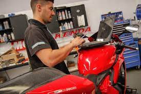 Young Motorcycle Workshop Crew Deliver Motorbike Writer