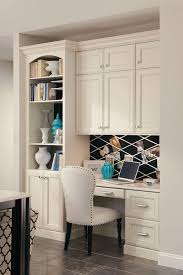 A Built In Desk With Bookcase And Cabinets Creates A Seamless Home Office In A Kitchen Corner Home Home Office Design Built In Desk