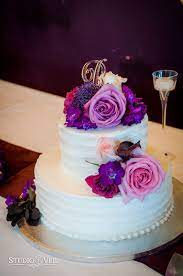 Two Tier Wedding Cake White Cake Purple Flowers Roses Photographed By Studi Wedding Cake Purple Flowers Wedding Cakes With Flowers Purple Wedding Cakes