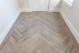 Wood Looking Tile Installed In A Herringbone Pattern With A Single Row Border Herringbone Wood Floor Wood Tile Bathroom Floor Wood Look Tile
