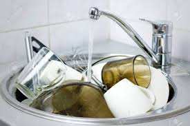 many dirty dishes in the kitchen sink