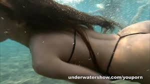 Julia and Masha are swimming nude in the sea