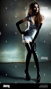 Young sexy goth woman on wall background Stock Photo - Alamy