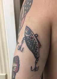 Fishing tattoos can take form in a number of ways, from large scenic designs to small tattoos like a bold little fishing lure, whatever you choose it'll certainly be a design worth showing off. American Traditional Tattoo Fishing Lure Fish Tackle Bait American Traditional Tattoo Traditional Tattoo Tattoos For Guys