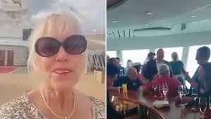 And they're off… again! Moment passengers cheer and glasses clink as the  'cursed' cruise ship sets sail after being stranded in Belfast for four  months