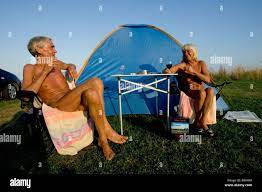 A couple enjoys the late afternoon outside their tent at a nudist  campground in Denmark Stock Photo - Alamy