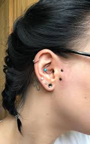 This piercing passes through no cartilage and is classified as a surface piercing, not an ear piercing. My New Surface Piercing Gill Piercing Sideburn Piercing Vertical Tragus Piercing Vertical Tragus Piercing Behind Ear Tattoo Tragus Piercings