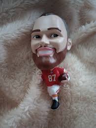 The Patrick Mahomes action figure has been released, featuring Patrick with  a lifelike Kermit voice! Accessories include 3 Lombardi trophies, a bottle  of ketchup and a can of 💩 beer. Annoying wife