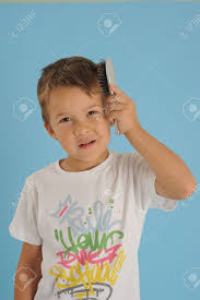 Pulling your child's hair back into a tight ponytail, braid, or bun causes trauma to the hair follicles. Boy Brushing Mis Hair Stock Photo Picture And Royalty Free Image Image 11031092
