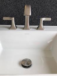 Find the nut on the drainpipe surrounding the pivot rod. K R22477 4d Maxton Widespread Bathroom Sink Faucet Kohler