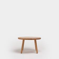 Button tufting is the final element, contrasting soft luxury with rustic grit. Coffee Table One Round Oak Series One Furniture Another Country