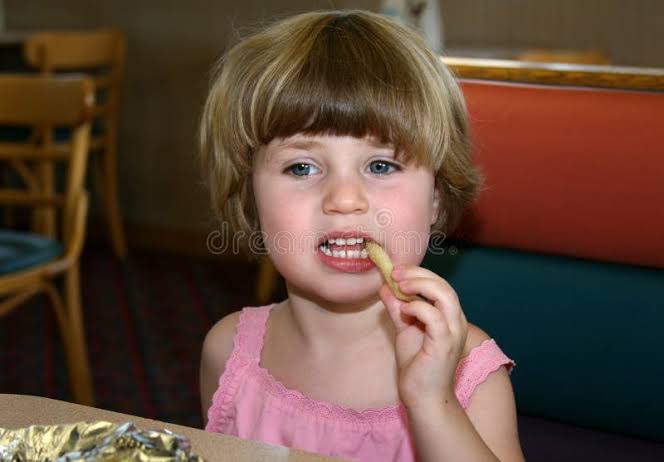 Little Girl Eating French Fry Stock Photos - Free & Royalty-Free Stock Photos from Dreamstime