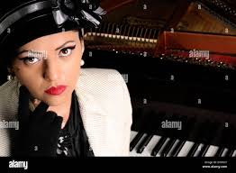 Sitting at the piano hi-res stock photography and images