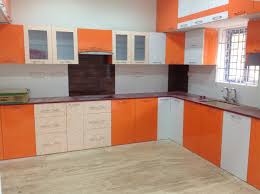orange and white themed modular kitchen