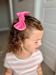 Pretty in pink 💕 Our handmade velvet bow is the perfect pop of color for  your little cutie's curls! Made with love and lots of sass ✨  #HandmadeWithLove #KidsAccessories #VelvetBow #ToddlerStyle #BowObsession #