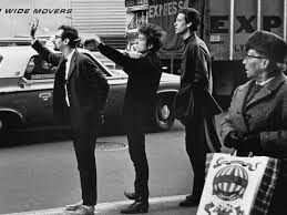 Peter Yarrow, Bob Dylan, and John Hammond Jr. hailing a cab in NYC (1965)  📸 - Photo by Daniel Kramer