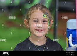 St. Petersburg, FL. USA; Pediatric cancer and chairperson Caroline Gallagher  poses with filled donation jars durning a fundraiser