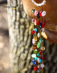 When you have your crimp in place, you compress it with crimping pliers , which curls/bend the crimp bead and seals the connection. Glass Bead Sun Catcher Tutorial