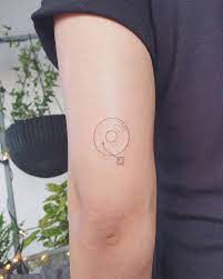 Black and red music note heart tattoo. Minimalist Turntable Tattoo On The Tricep