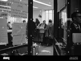 Marlene Dixon, an assistant social science professor whose contract with  the University of Chicago won't be renewed after this year, holds a  newspaper as she is surrounded by students in the university's