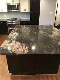 You can go with an acrylic top coat with something that's in a high gloss that'll go on there. Black Magma Granite Dark Granite Countertops Black And Copper Kitchen Granite Countertops