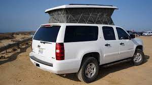 A refrigerator, custom built shelves, ample storage for adventure gear. Chevy Suburban Camper Is Chock Full Of Neat Features