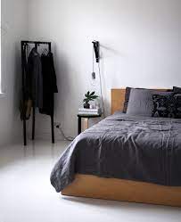 Clean Headboard Small Simple Nightstand Cord Light Exposed Clothes Rack No Rug Mens Bedroom Home Decor Bedroom Minimalist Bedroom