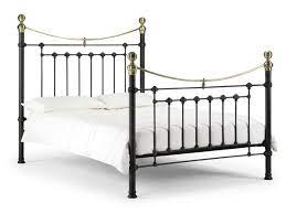 Beautiful crafted out of brass, this bedstead with decorative slender posts and round finials features head and footboard with beautiful authentic black and white cowhide twin bed frame with nailhead trim. Julian Bowen Victoria 4ft6 Double Satin Black And Brass Metal Bed Frame