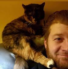 Breakthrough! After one year of Gideon's re-homing and not being a cuddle  or lap cat whatsoever, he finally snuggled up to his owner (my daughter) as  she laid