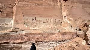 Sounds like it could be a dog. Cool. I know domesticated house cats weren't  likely around these parts while these pictographs were created. But that  dark one