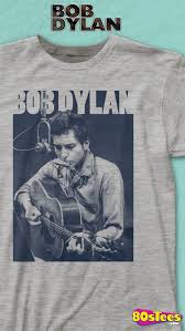 this bob dylan t shirt shows the legendary musician playing his guitar and harmonica in a recording studio bob dylan is one of th bob dylan dylan mens tshirts