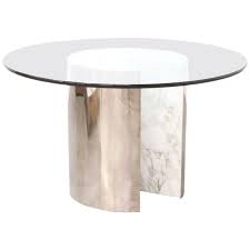 When talking about dining table, most of the people will think about wood dining table. Vintage Stainless Steel And Carrera Marble Dining Table With Glass Top Dining Table Marble Marble Tables Design Marble Dining