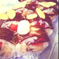 Dessert Sushi Banana Strawberries Wrapped In Sweet Sticky Rice Rolled In Coconut And Drizzled With Chocolat Sweet Recipes Dessert Sushi Sweet Sticky Rice